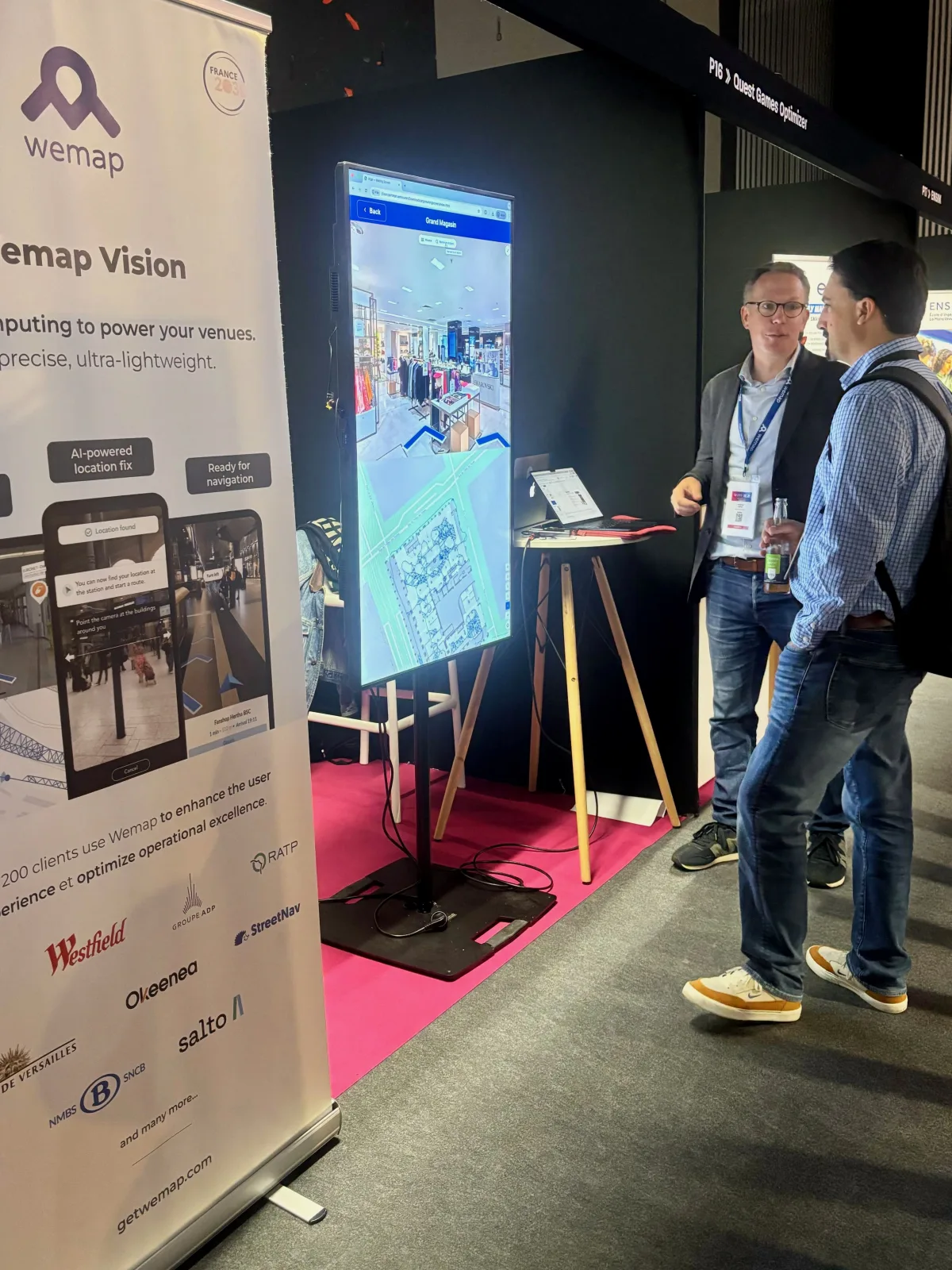 The Wemap team at their booth during a trade show