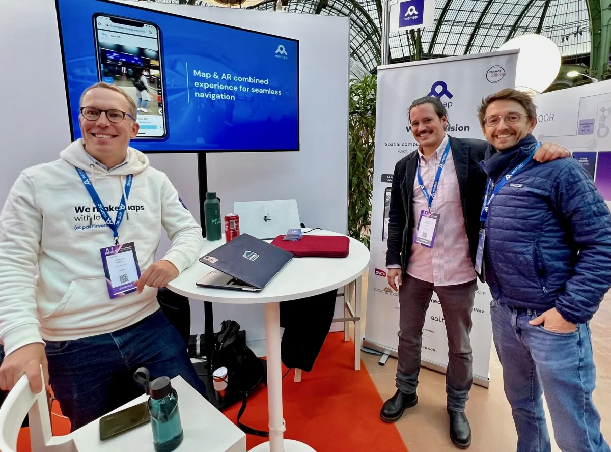 The Wemap team at their booth during a trade show
